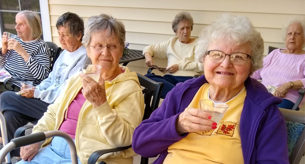 elderly residents outside in sun