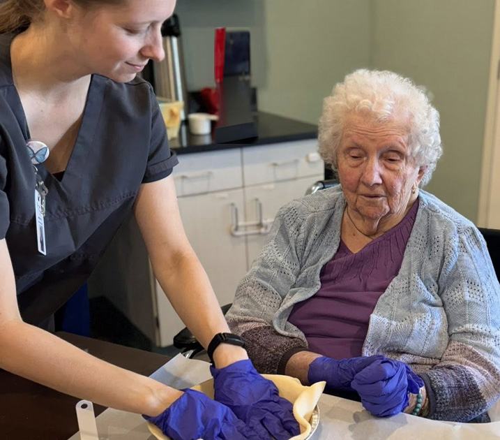 nursing helping memory care patient